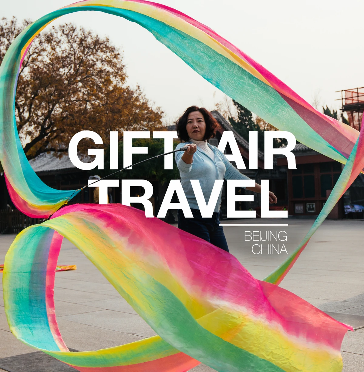 Skyhour post: a woman dancing with long rainbow ribbons in Beijing, “Gift air travel”