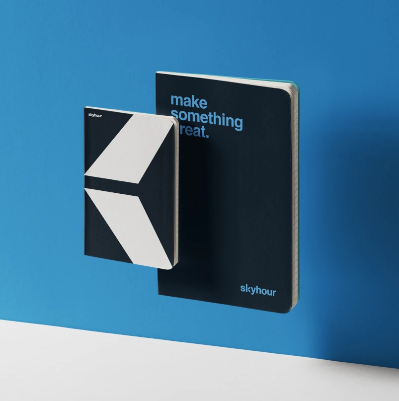Skyhour notebooks in dark blue with the line “make something great.”