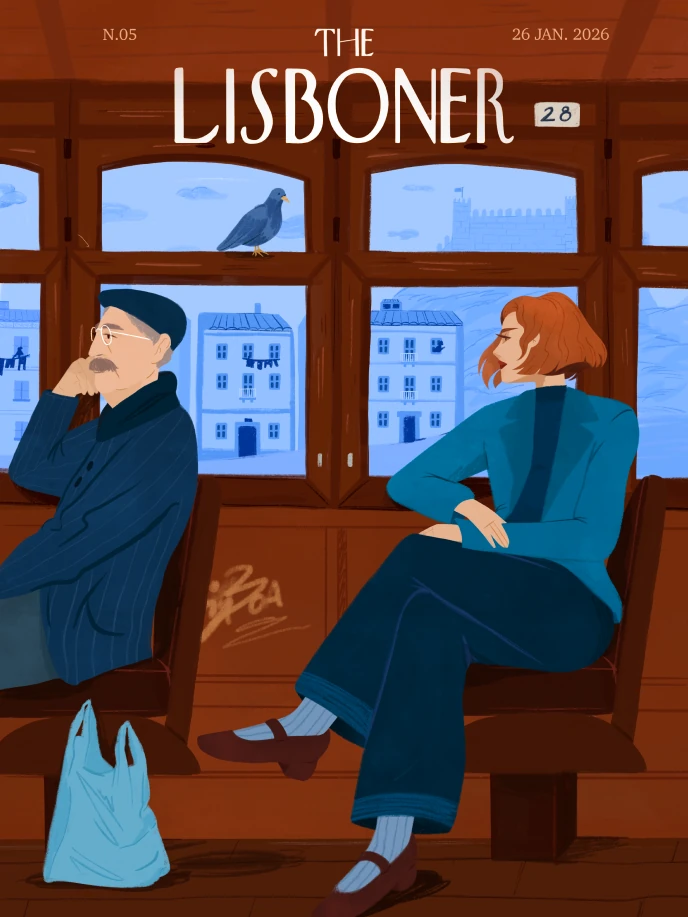 The Lisboner magazine cover: an older man and a red-haired woman riding Lisbon's tram 28, a pigeon on the window ledge